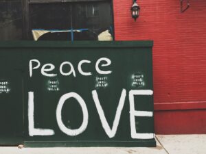 Peace Love painted on green wall
