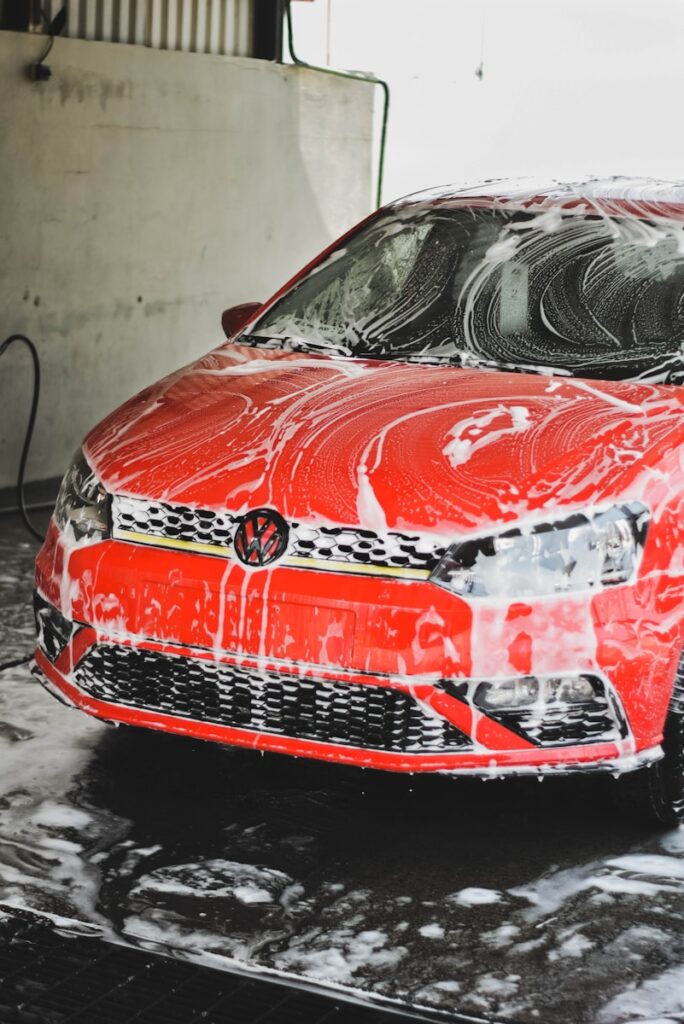 a red car is covered in a lot of snow